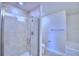 Bathroom featuring a glass-enclosed shower with a tile surround, and a white toilet and soaking tub at 1497 Leamington Ln, Winter Haven, FL 33884