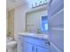 Bathroom with white vanity, granite countertop, large mirror, shower, and toilet at 1497 Leamington Ln, Winter Haven, FL 33884