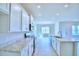 Spacious kitchen with white cabinets and an island that offers plenty of prep space and open views to living area at 1497 Leamington Ln, Winter Haven, FL 33884
