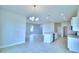 Bright and airy kitchen with island, pendant lighting, tile floors, and an open layout at 1497 Leamington Ln, Winter Haven, FL 33884