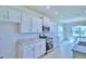 Bright kitchen featuring white cabinets, stainless steel appliances and plenty of countertop space for meal prep at 1497 Leamington Ln, Winter Haven, FL 33884