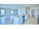 Open kitchen features an island with a sink and dishwasher, and views into a large living area with windows at 1497 Leamington Ln, Winter Haven, FL 33884