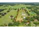 Aerial view shows property lines and outlines surrounding expansive acreage, ponds, and outbuildings at 15195 Angus Rd, Polk City, FL 33868