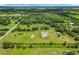 Expansive aerial view of a home and its surrounding acreage with a small pond at 15195 Angus Rd, Polk City, FL 33868