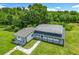 Aerial view of this home with lots of land featuring well-maintained pastures and mature landscaping for privacy and beauty at 15195 Angus Rd, Polk City, FL 33868
