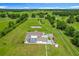 Aerial view of property featuring a large lot, fenced backyard, mature landscaping, and expansive driveway at 15195 Angus Rd, Polk City, FL 33868