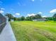 Expansive backyard featuring a spacious lawn, mature trees, and storage sheds, ideal for outdoor activities and relaxation at 15195 Angus Rd, Polk City, FL 33868