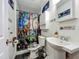 A charming bathroom with a unique shower curtain and toilet seat cover at 15195 Angus Rd, Polk City, FL 33868