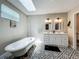 Bright bathroom featuring double vanity, clawfoot tub and decorative tile at 15195 Angus Rd, Polk City, FL 33868