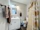 Small bathroom features a single sink vanity, toilet, and shower/tub with a decorative curtain at 15195 Angus Rd, Polk City, FL 33868
