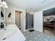 Bathroom featuring double vanity, shower, decorative tile, and access to bedroom at 15195 Angus Rd, Polk City, FL 33868