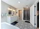 Bright bathroom featuring double vanity, shower and decorative tile at 15195 Angus Rd, Polk City, FL 33868