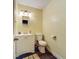 Small bathroom features a single sink vanity, toilet, and dark tile floors at 15195 Angus Rd, Polk City, FL 33868