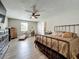 Spacious bedroom with wood floors, ceiling fan, sitting area, and double door closet for ample storage at 15195 Angus Rd, Polk City, FL 33868