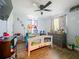 A cozy bedroom with a decorated bed frame, ceiling fan, and curtains at 15195 Angus Rd, Polk City, FL 33868
