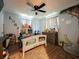 A cozy bedroom with a decorated bed frame, ceiling fan, and curtains at 15195 Angus Rd, Polk City, FL 33868
