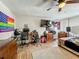 Bedroom with desk space, wood floors, ceiling fan, and wall decor at 15195 Angus Rd, Polk City, FL 33868