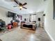 Bedroom with wood floors, ceiling fan, TV, and decorative posters at 15195 Angus Rd, Polk City, FL 33868