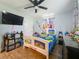 A cozy bedroom with a decorated bed frame, ceiling fan, and curtains at 15195 Angus Rd, Polk City, FL 33868