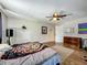 Cozy bedroom with wood floors, ceiling fan, and a view of the decorations on the wall at 15195 Angus Rd, Polk City, FL 33868
