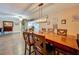 Inviting dining area offering modern wood flooring, a pendant light, and a peek into the living area at 15195 Angus Rd, Polk City, FL 33868
