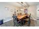 Dining room featuring wood-look floors, modern chandelier, and neutral paint scheme at 15195 Angus Rd, Polk City, FL 33868