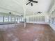 Large empty room with tiled floors and windowed walls at 15195 Angus Rd, Polk City, FL 33868