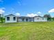 The back of this single Gathering home features an enclosed patio and well maintained lawn at 15195 Angus Rd, Polk City, FL 33868