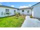 Charming home with a front entrance walkway surrounded by a small garden and lush green lawn at 15195 Angus Rd, Polk City, FL 33868