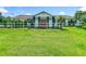 Home exterior featuring a well-maintained lawn and a white fence, offering a tranquil and inviting curb appeal at 15195 Angus Rd, Polk City, FL 33868