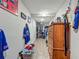 Well-lit hallway leading to a closet and wooden dresser at 15195 Angus Rd, Polk City, FL 33868