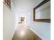 Hallway has wood flooring and a mirror hanging on the wall at 15195 Angus Rd, Polk City, FL 33868