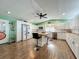 A bright kitchen equipped with white cabinetry, wood countertops, a central island, and stainless steel appliances at 15195 Angus Rd, Polk City, FL 33868