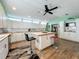 Bright kitchen with white cabinetry, wood countertops, island with seating, and stainless steel appliances at 15195 Angus Rd, Polk City, FL 33868