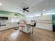 Spacious kitchen featuring white cabinets, wood countertops, a central island with bar stools, and wood flooring at 15195 Angus Rd, Polk City, FL 33868