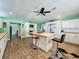Well-lit kitchen featuring white cabinetry, a butcher block island, and modern stools at 15195 Angus Rd, Polk City, FL 33868