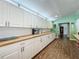 An expansive kitchen featuring ample white cabinetry, wood countertops, and modern appliances at 15195 Angus Rd, Polk City, FL 33868