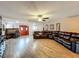 Spacious living room featuring wood floors, a ceiling fan and a large leather sectional sofa at 15195 Angus Rd, Polk City, FL 33868