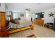 An airy main bedroom featuring a king bed, light wood floors, and an ensuite bathroom at 15195 Angus Rd, Polk City, FL 33868