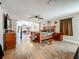 Spacious main bedroom with a king-sized bed, wooden furniture, and view towards a fireplace at 15195 Angus Rd, Polk City, FL 33868