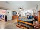 Large bedroom with sliding barn door, TV, and wooden furniture, offering a view to a fireplace at 15195 Angus Rd, Polk City, FL 33868