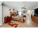 A spacious main bedroom includes a large bed, wooden furniture, and a view towards the laundry area at 15195 Angus Rd, Polk City, FL 33868