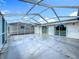 Covered and screened patio with an empty, light-colored floor at 15195 Angus Rd, Polk City, FL 33868