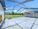 Wide screened patio offers views of the green yard at 15195 Angus Rd, Polk City, FL 33868