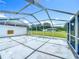 View from the screened patio shows a large grassy yard at 15195 Angus Rd, Polk City, FL 33868