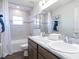 Bathroom featuring double sinks, granite countertop, and tiled shower with tub at 1537 Otter Woods Ln, Auburndale, FL 33823