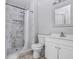 Bathroom with white marbled tile shower and white vanity with modern finishes at 169 Birmingham Dr, Kissimmee, FL 34758