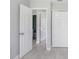 Bedroom with doorways to bathroom and bedroom and featuring wood-look flooring at 169 Birmingham Dr, Kissimmee, FL 34758
