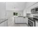 Bright, open kitchen with granite countertops, stainless appliances, and view to backyard at 169 Birmingham Dr, Kissimmee, FL 34758