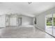 Open living room with tile floors, a sliding glass door, and a neutral color palette at 169 Birmingham Dr, Kissimmee, FL 34758